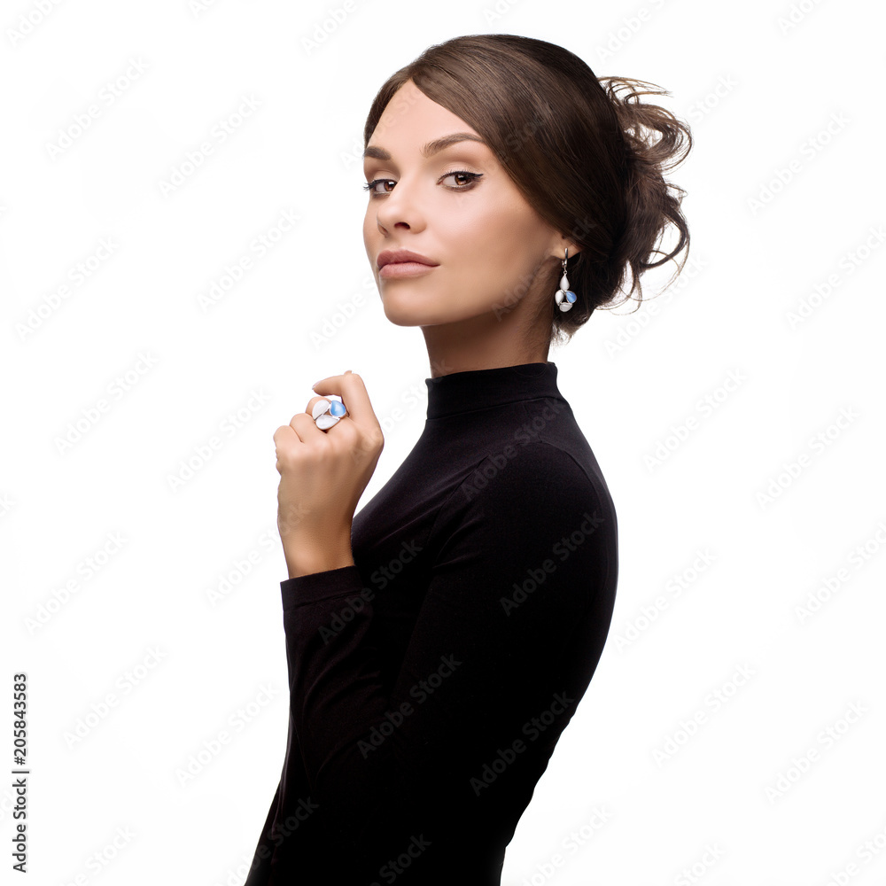 Beautiful, young brunette girl in black clothes with jewelry Beautiful, young brunette girl in black clothes with jewelry