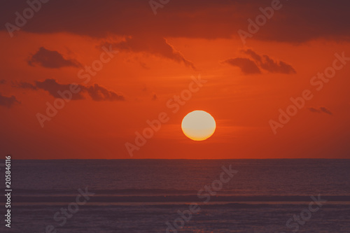 Sunrise over ocean horizon photographed with big telephoto lens. © astrosystem