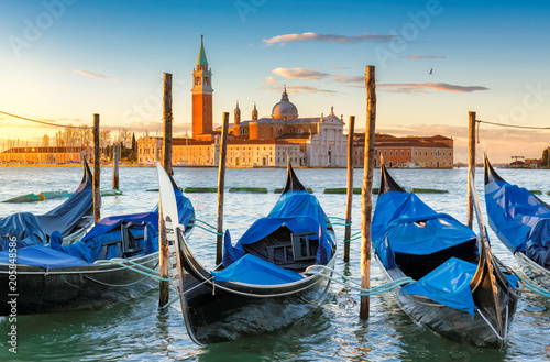 Venice sunrise. Gondolas by Saint Mark square with San Giorgio di Maggiore church in Venice, Italy,