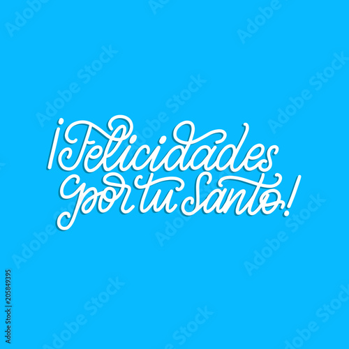 Felicidades Por Tu Santo translated from Spanish handwritten phrase Congratulations For Your Saint on blue background.