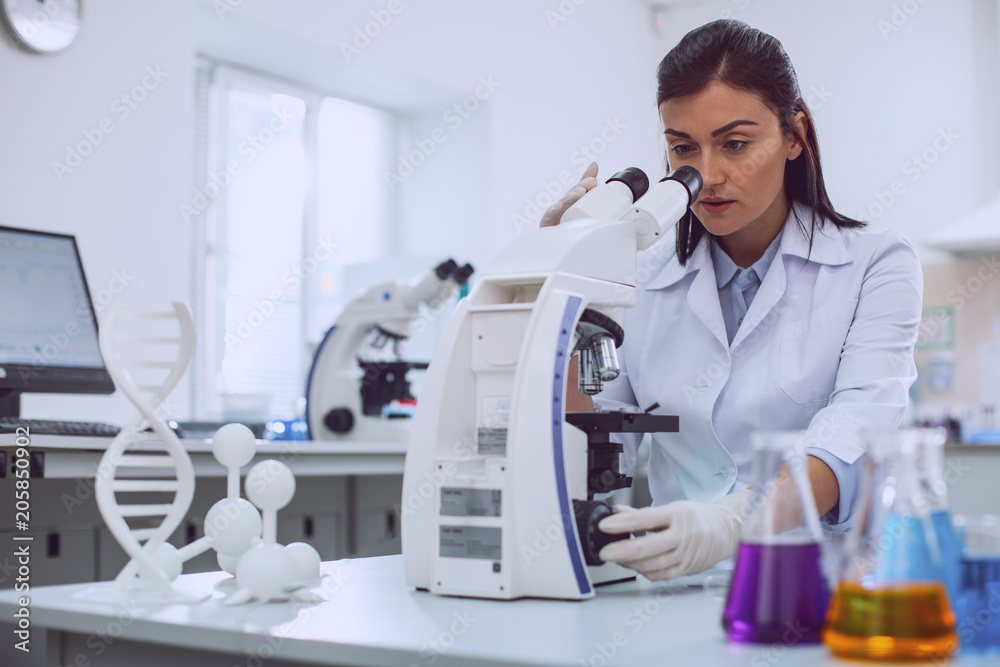 I love science. Concentrated professional biologist wearing a uniform and looking into the microscope I love science. Concentrated professional biologist wearing a uniform and looking into the microscope