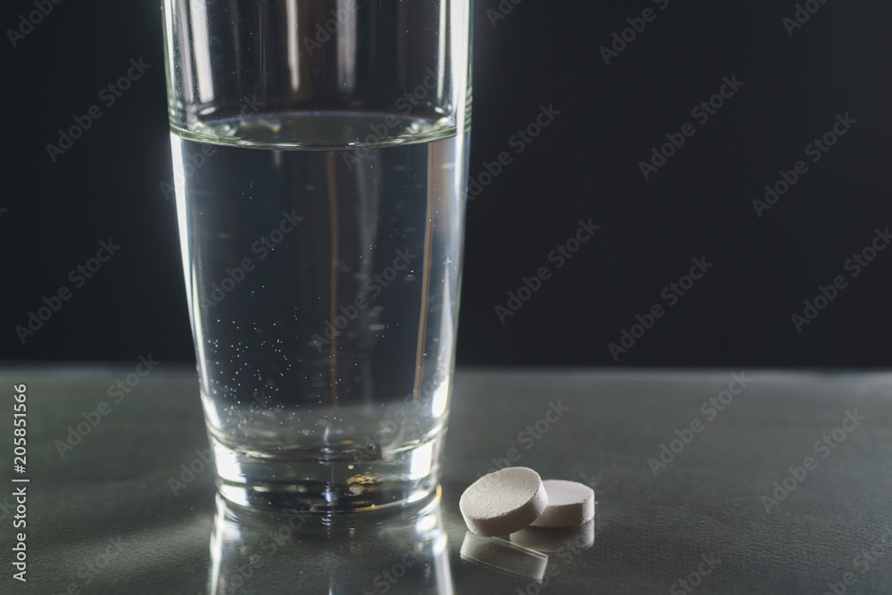 Effervescent tablet in water with bubbles Effervescent tablet in water with bubbles