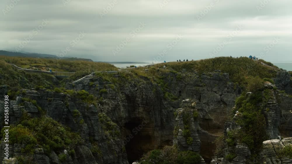Drone shot couple walking on Pancake Rocks lookout at Punakaiki Drone shot couple walking on Pancake Rocks lookout at Punakaiki
