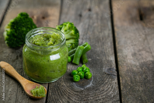 Green baby food purees in glass jars