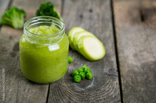 Green baby food purees in glass jars