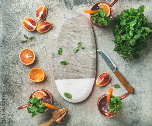 Photography Blood orange Moscow mule alcohol cocktails with fresh mint leaves and ice in cop