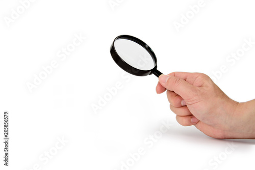 Hand holding magnifying glass isolated on white background