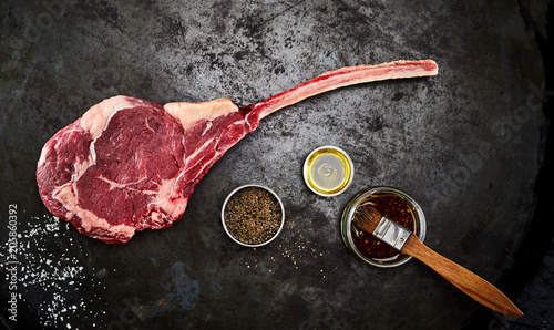 Tender raw trimmed bone-in ribeye steak photo