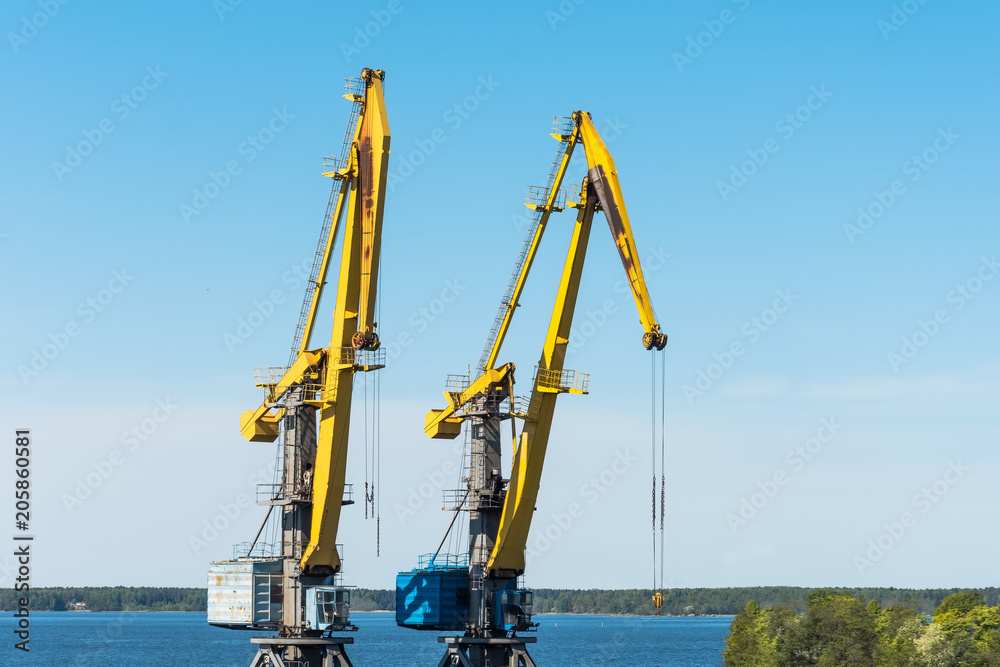 Two high sea cranes for loading containers of cargo on ships and trains. Two high sea cranes for loading containers of cargo on ships and trains.