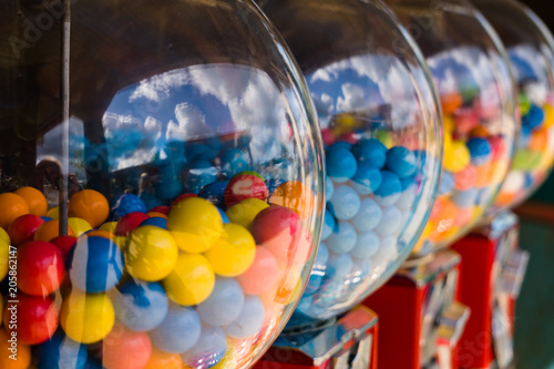A few gumball machines in a row