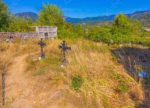 Old abandoned cemetery with wrought iron crosses
