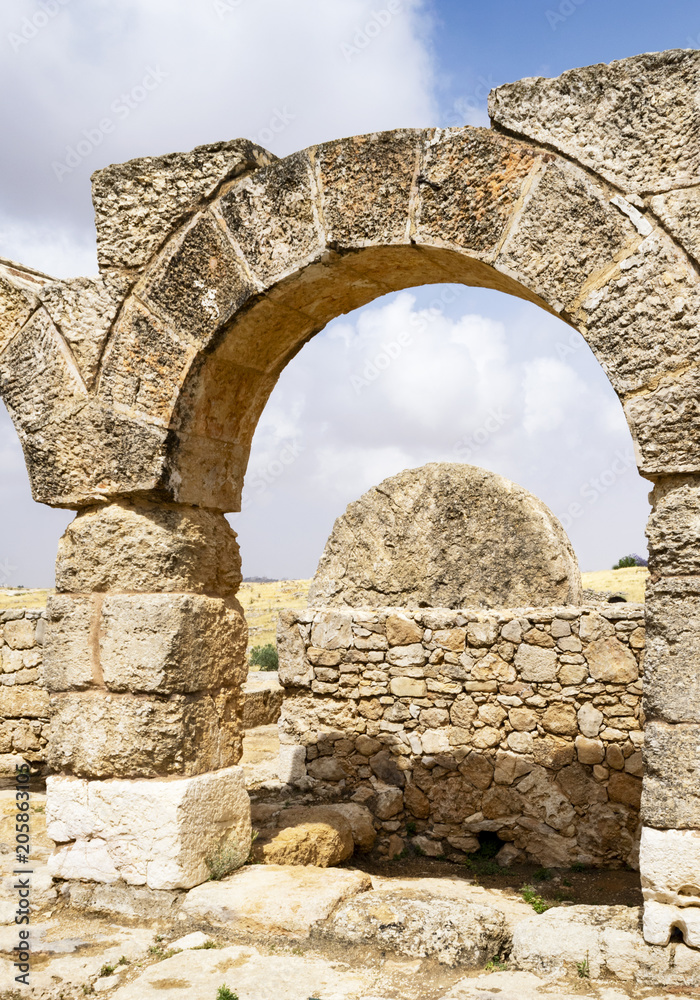 the massive rolling stone door of the ancient Susya synagogue viewed from the courtyard