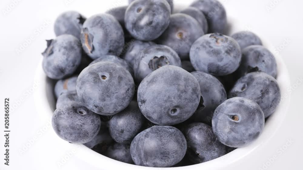 Bowl with raw blueberries on white background Bowl with raw blueberries on white background