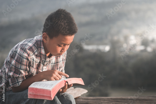 boy reading the scriptures.