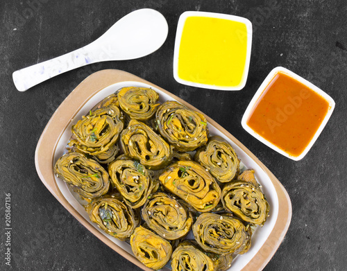 Indian Spicy Food Patra Also Called Paatra, Alu Vadi or Patrode is a Veg Dish in Maharashtra or Gujarati Cuisine. It is Made from Colocasia Leaves Stuffed with Rice Flour And Spices, Tamarind, Jaggery photo