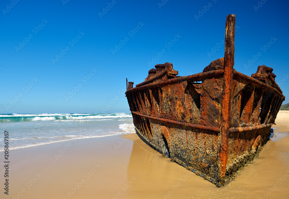 Rusty stranded, sunken 'Maheno' vessel at Fraser island beach. Queensland, Australia.