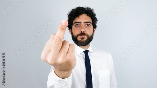 Fuck You. Handsome brunette man with shirt giving the finger.