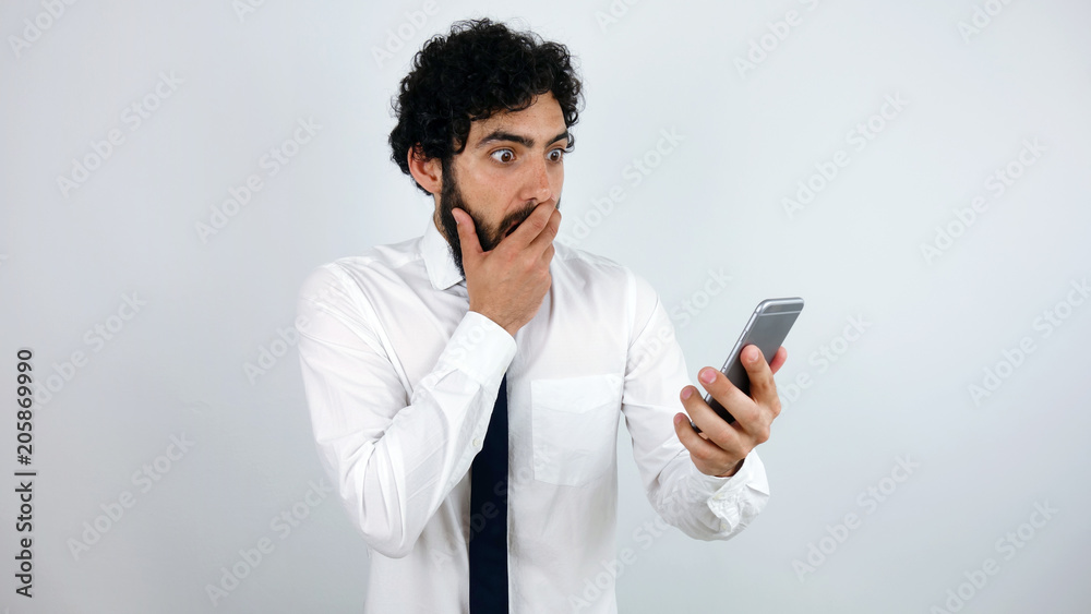 Business man with mobile phone in his hand surprised and surprised and scared. Business man with mobile phone in his hand surprised and surprised and scared.