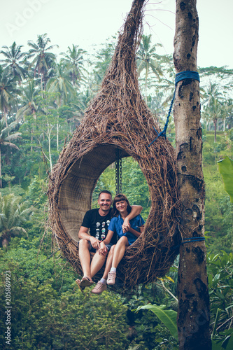 Traveler honeymoon couple in the jungle of Bali island, Indonesia. Couple in the rainforest. photo