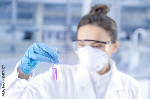 Female scientist looking at the scientific sample in the CDC laboratory