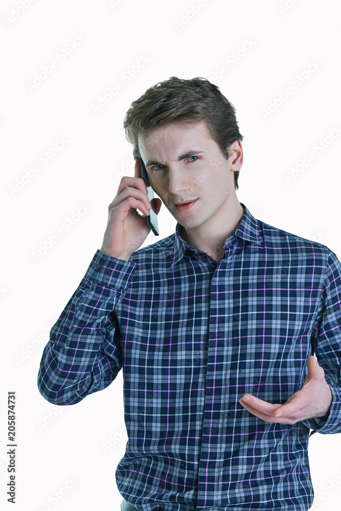Closeup portrait of young, serious business man, corporate employee, student talking on cell phone. Closeup portrait of young, serious business man, corporate employee, student talking on cell phone.