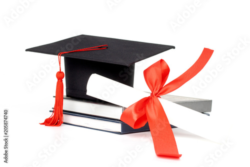Graduation hat, book and diploma isolated on white background