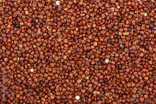 red quinoa seeds as a background. Top view