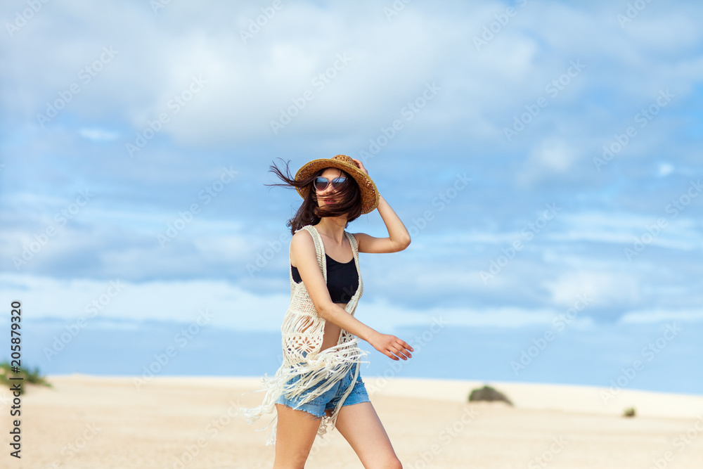 Beautiful boho styled woman posing on the desert Beautiful boho styled woman posing on the desert