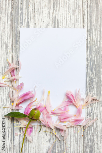 Fototapeta Naklejka Na Ścianę i Meble -  Mockup with postcard and flowers on wooden background