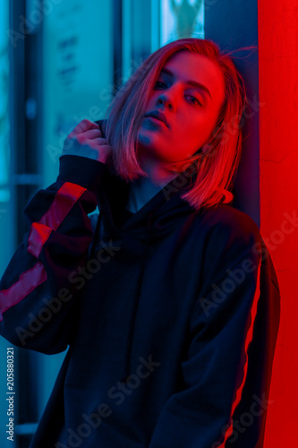 portrait of a girl in red blue in the street