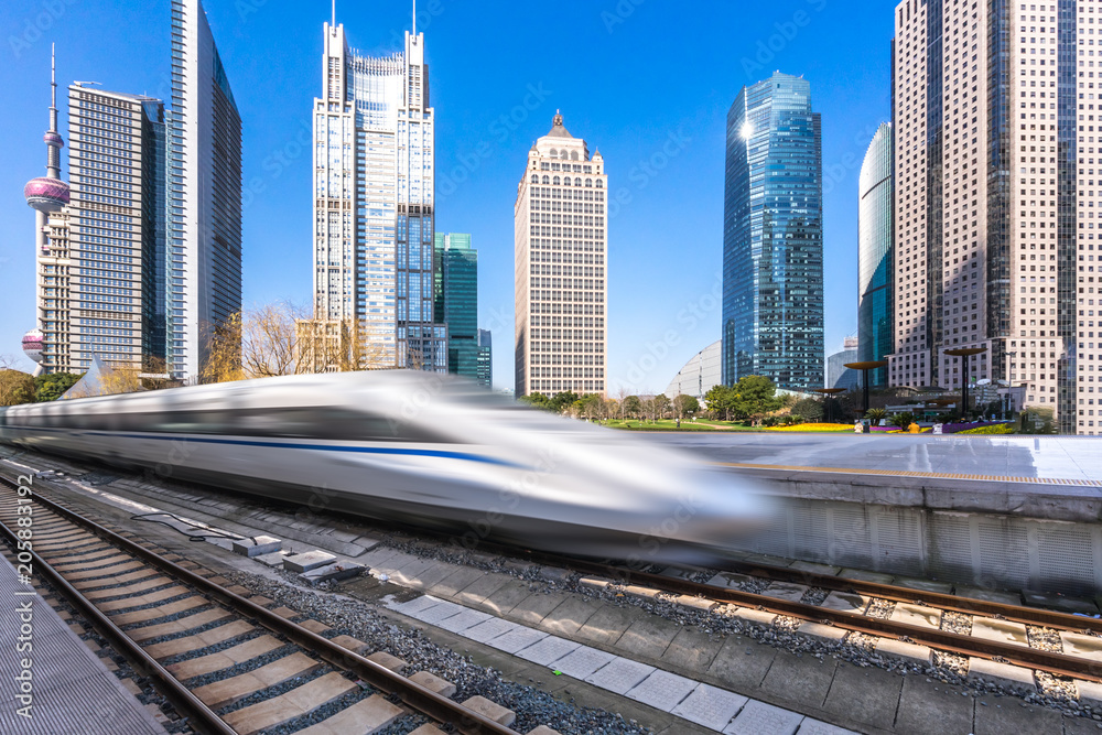 Naklejka premium high speed train with city skyline in shanghai