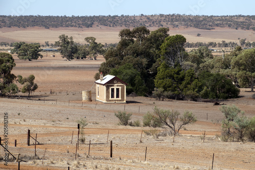 Quorn South Australia, view across bare plain to rolling hills with small farmhouse in foreground