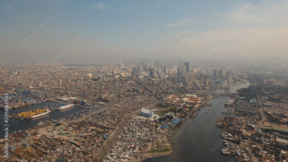 Aerial view skyline of Manila city. Fly over city with skyscrapers and buildings. Aerial skyline of Manila . Modern city by sea, highway, cars, skyscrapers, shopping malls. Makati district. Travel