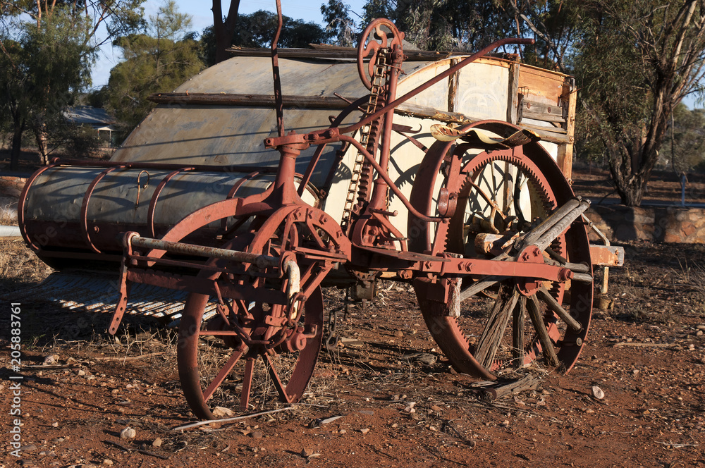 Quorn South Australia, obsolete crop harvester left to rust in the afternoon sunlight