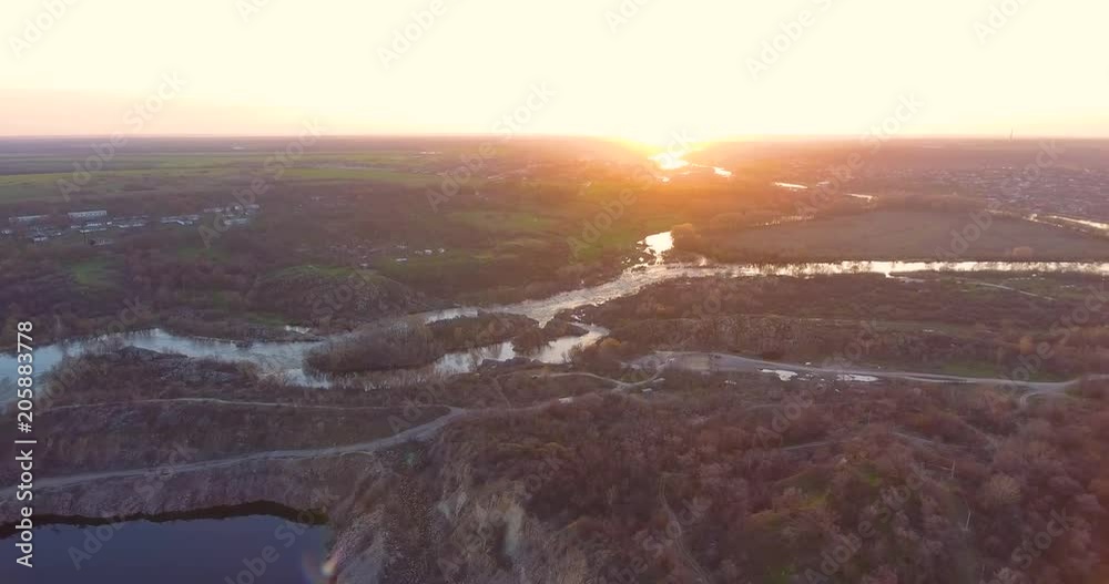 Aerial View: Flight over the flooded granite quarry and beautiful river. Sunset soft light. Aerial View: Flight over the flooded granite quarry and beautiful river. Sunset soft light.