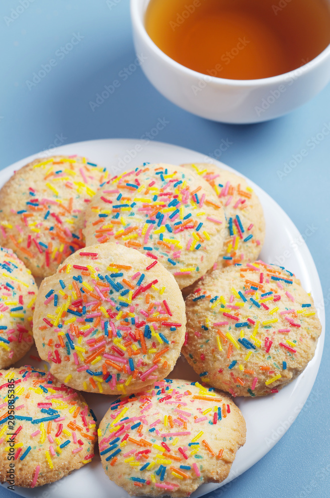 Cookies with colorful sprinkles and tea Cookies with colorful sprinkles and tea