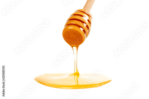 honey with wooden drizzler isolated on white background
