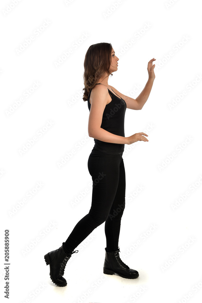 full length portrait of brunette girl wearing black singlet, jeans jeans and boots. standing pose, isolated on white studio background. full length portrait of brunette girl wearing black singlet, jeans jeans and boots. standing pose, isolated on white studio background.