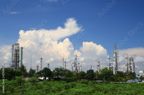 Petrochemical industry and cassava field in blue sky background