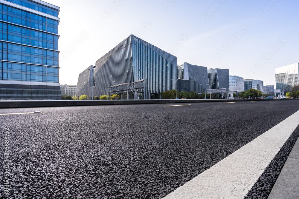 Fototapeta premium empty road with panoramic city skyline
