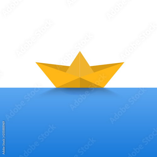 Paper boat yellow color on a blue sea