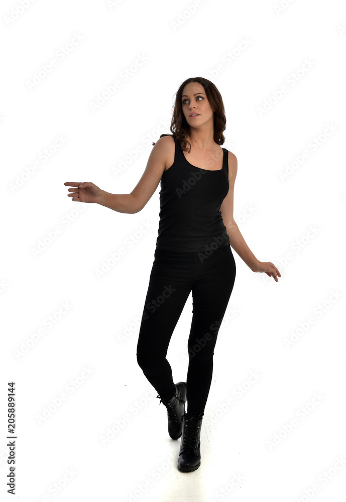 full length portrait of brunette girl wearing black singlet, jeans jeans and boots. standing pose, isolated on white studio background. full length portrait of brunette girl wearing black singlet, jeans jeans and boots. standing pose, isolated on white studio background.
