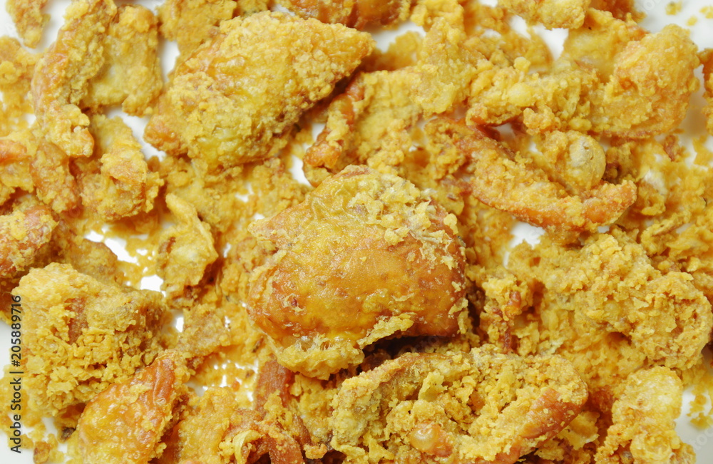 deep fried chicken skin with salt and pepper on white plate deep fried chicken skin with salt and pepper on white plate
