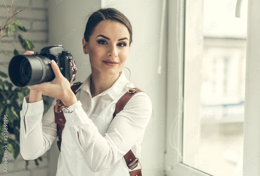 Pretty woman is a professional photographer with dslr camera Pretty woman is a professional photographer with dslr camera