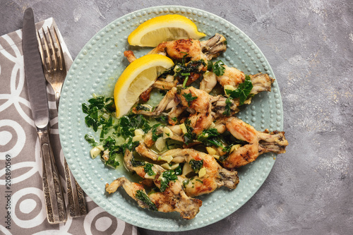 Frog legs baked with garlic butter and parsley.