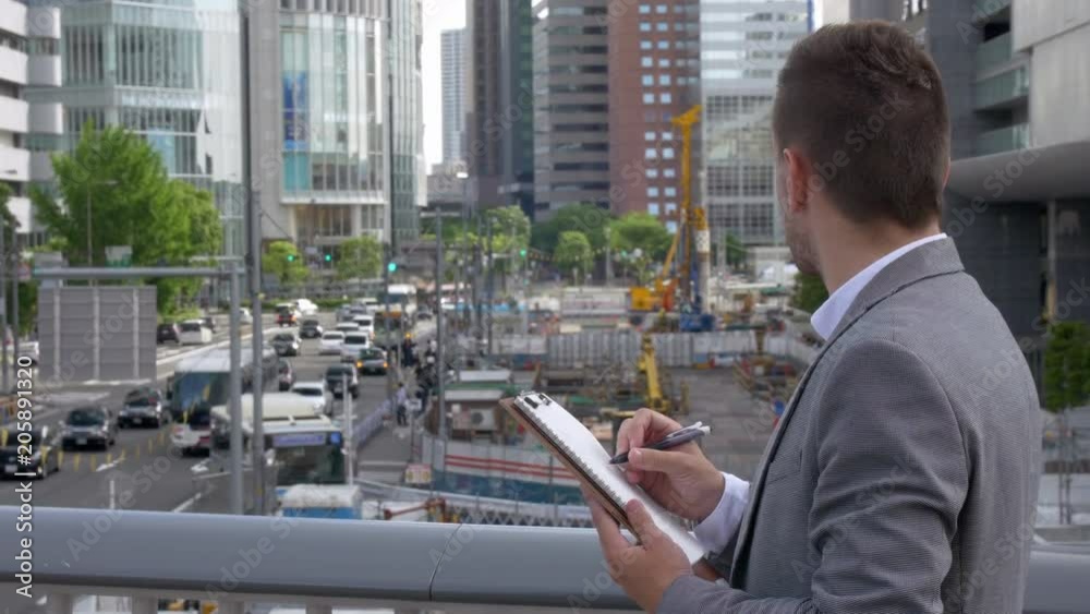 Caucasian business man checking building site Japan. Caucasian business man checking building site Japan.