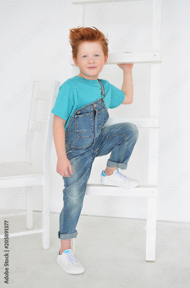 Portrait of red-haired naughty boy looking at the camera. Cute and beatiful children. Portrait of red-haired naughty boy looking at the camera. Cute and beatiful children.