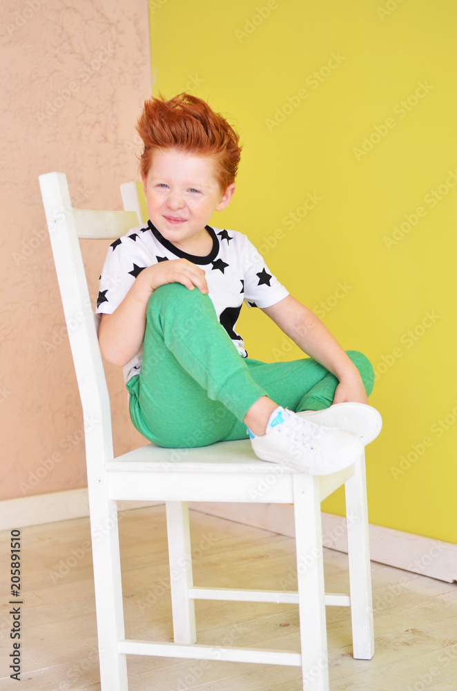 Portrait of red-haired naughty boy looking at the camera. Cute and beatiful children. Portrait of red-haired naughty boy looking at the camera. Cute and beatiful children.