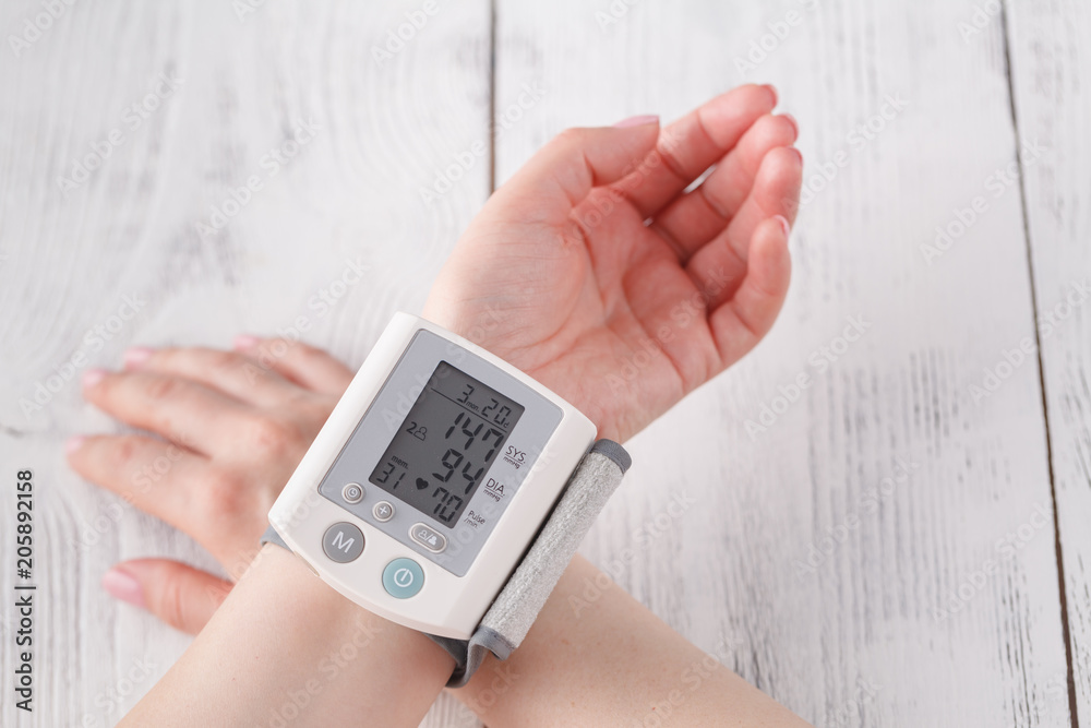 Senior woman measuring blood pressure. Health care background Senior woman measuring blood pressure. Health care background