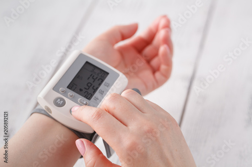 Senior woman measuring blood pressure. Health care background